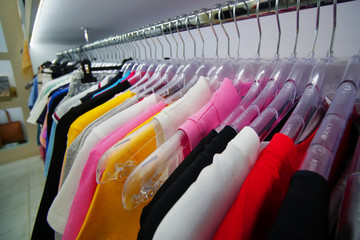 clothes hanging on hangers in the store