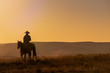 Lone Desert Cowboy Riding At Sunrise