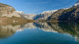 Fototapeta Góry - Panoramic scenic view in Austrian alps. Hallstatt mountain village at Hallstatt lake. Sunny day lake view from Hallstatt alps mountains. Location: resort village Hallstatt, Austria, Alps. Europe.