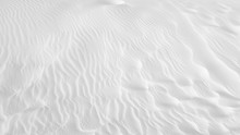 White Sand Texture Background With Wave Pattern And Insect Trails	