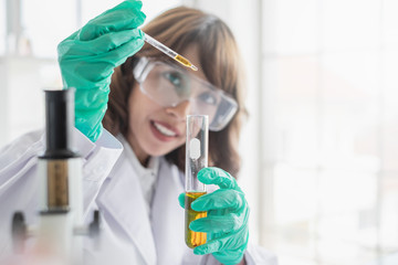 Wall Mural - a young asian woman scientist working in laboratory with test tube microscope and solutions.