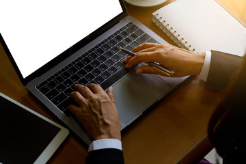 Wall Mural - Business woman hand work on laptop computer with blank white screen at home.