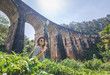Woman looks at the Demodara nine arches bridge the most visited sight of Ella town in Sri Lanka