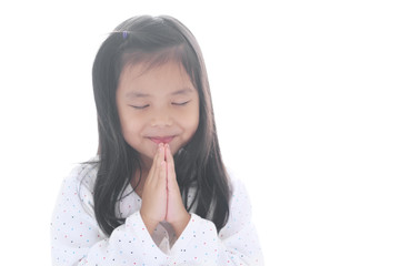 Wall Mural - Asian child smiling hand in hand or kid girl pay obeisance and pray close eye or hello welcome and thank you with wear white shirt in morning at church or temple for peace on white background isolated