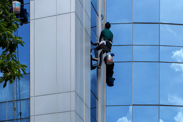 The building cleaner is climbing for clean building