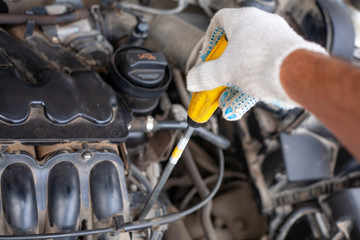 mechanic men with wrench repairing car engine at