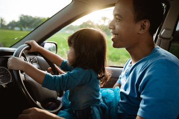 father daughter playing in the car together