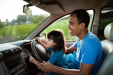 father daughter playing in the car together