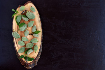 Organic fresh green  almonds on wood board