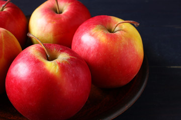 Canvas Print - Red apple Idared in a plate on a dark background