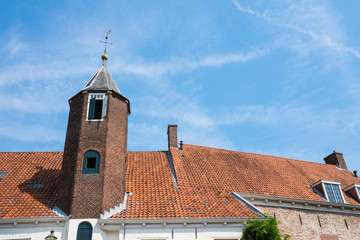 house with tower in street Muurhuizen in Amersfoort, The Netherlands. Blue sky, space for text