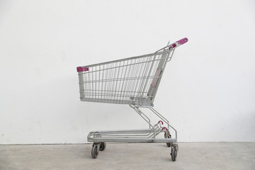 A old empty shopping cart on cement floor.