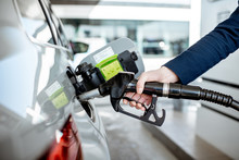 Man Refueling Car With Gasoline, Close-up View Focused On The Filling Gun