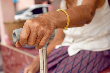 hands of old woman asia with a cane walking stick