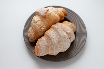 Wall Mural - fresh croissant on plate and  white background