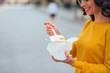 © bnenin - Eating tasty fast food in takeaway paper box, close-up, copy space.