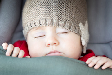 close-up portrait of a beautiful sleeping baby in stroller.