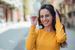 © bnenin - Headshot of a positive young woman with eyeglasses in the city, smiling at camera.