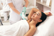 Calm woman having laser hair removal on the armpit