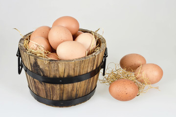 Wall Mural - Chicken eggs in wooden bowl