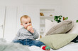 © Anastasiia - Very cute little toddler boy snacking. Baby or small child eating a piece of bread. Making funny silly face.