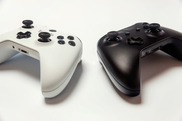 Poster - White and black two joystick gamepad, game console isolated on white background. Computer gaming technology play competition videogame control confrontation concept. Cyberspace symbol