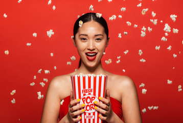 Wall Mural - Woman enjoying a movie with popcorn