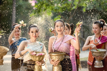 Vientiane Laos APRIL 4 2019 : Young happy beauty Asian woman splashing water during  Water Songkran festival ,Thailand Laos traditional.