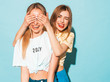 © halayalex - Girl surprising her female best friend. Model covering her eyes and hugging  from behind. Two surprised girls. Women having fun and showing face emotions