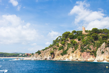 Wall Mural - Sea coast landscape in Lloret de Mar with old tower castle on rocky shore, Costa Brava, Spain