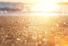 Background Image Of Sandy Beach And Ocean Waves With Bright Bokeh Lights