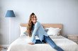 © BestForYou - Young beautiful smiling woman in living room at home.