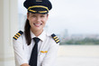 Portrait of a pretty female pilot smiling.