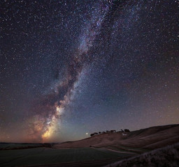 Wall Mural - Vibrant Milky Way composite image over landscape of ancient chalk white horse at Cherhill in Wiltshire