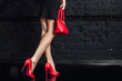 © Тарас Нагирняк - Photo of sexy, women's legs in red shoes on a black  background. Lifestyle!