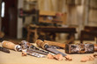 Carpenter tools. Chisel or gouge for wood on carpenter working at workbench. Carpentry workshop