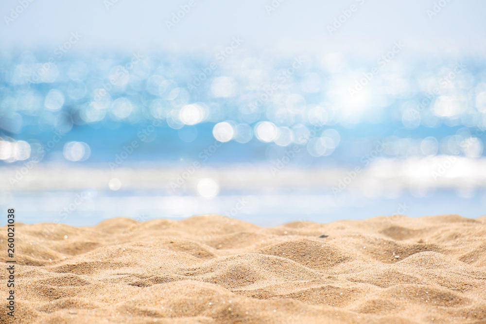 Seascape abstract beach background. blur bokeh light of calm sea and sky. Focus on sand foreground. - obrazy, fototapety, plakaty 