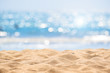 Leinwanddruck Bild - Seascape abstract beach background. blur bokeh light of calm sea and sky. Focus on sand foreground.