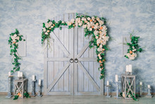 Blue Decorative Gates With Flowers And Candles. Photo Zone In An Interior Photo Studio