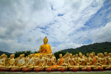 Wall Mural - Take photo of  Buddha statue sitting   image of 1250 monks chant around the Buddha image at  Phuttha Utthayan Makha Bucha Anusorn