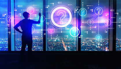 Wall Mural - Question marks with man writing on large windows high above a sprawling city at night