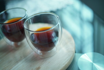 Close up shot of coffee glass on wood plate