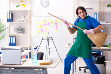 Male handsome professional cleaner working in the office 