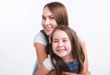 family, children and parenthood concept - young woman with her little cute child on white background