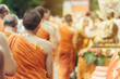 © JinnaritT - Group of Monks bath Buddha sculputer purify body and spirit in Songkran festival, Thailand
