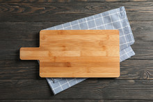 Cutting Board With Kitchen Towel On Wooden Background, Space For Text