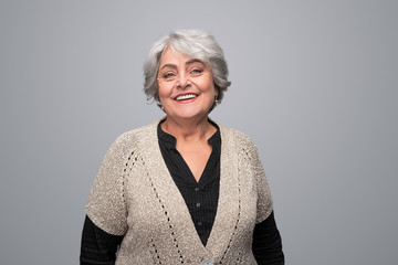 Smiling elderly woman looking at camera