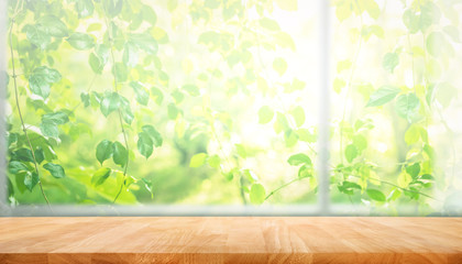 Wall Mural - Wood table top on blur of window with garden flower background in morning