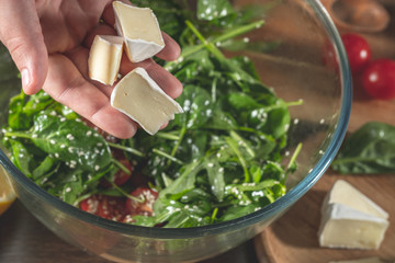 Wall Mural - Salad with  cheese on background with ingredients.