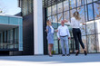 © Drpixel - Group of colleagues and business people having conversation during coffee break in front of an office building
